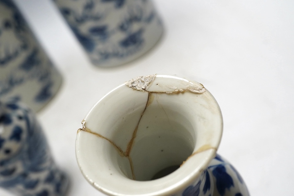 A pair of Chinese blue and white cylindrical brushpots and a smaller pair, tallest 29cm. Condition - both smaller vases with heavy repairs